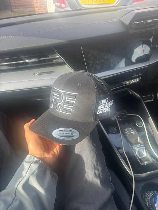black and white REVALT “TAKE RISKS AND PROSPER” cap
