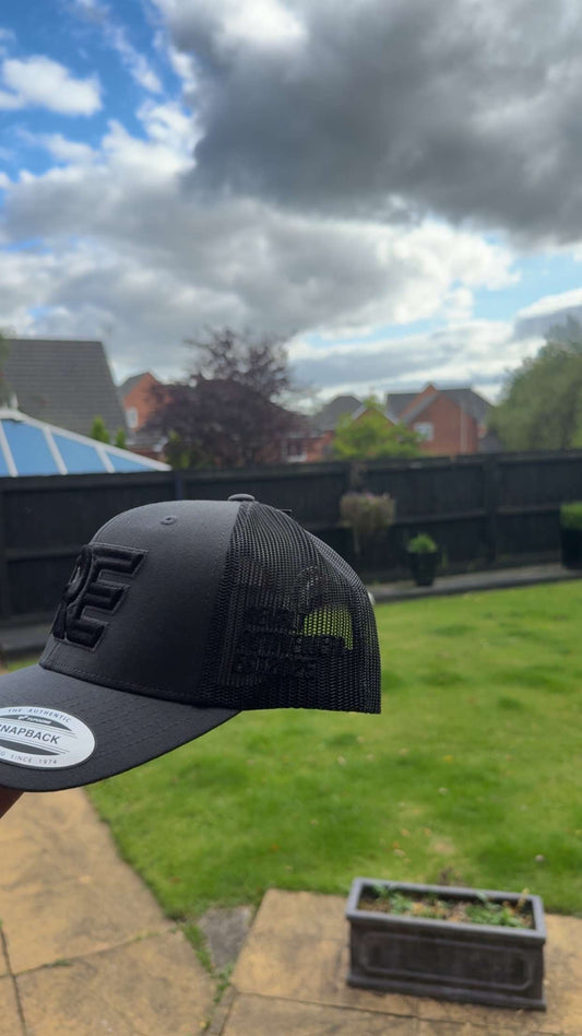 grey and black REVALT “TAKE RISKS AND PROSPER” cap