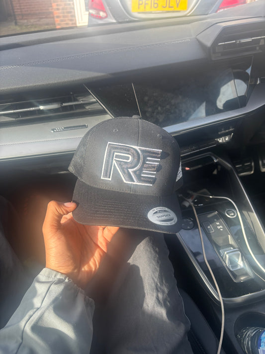 black and white REVALT “TAKE RISKS AND PROSPER” cap