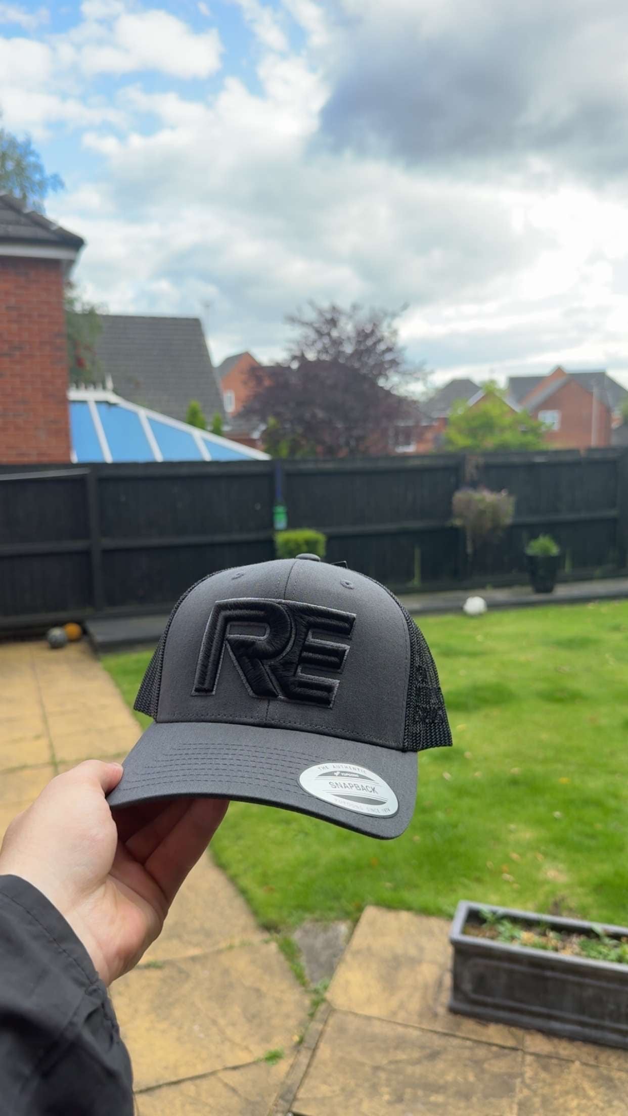 grey and black REVALT “TAKE RISKS AND PROSPER” cap