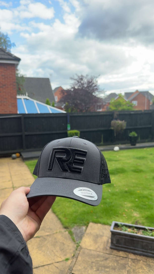 grey and black REVALT “TAKE RISKS AND PROSPER” cap
